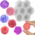 Silicone mold with rose shapes and colorful rose-shaped candies on a white background