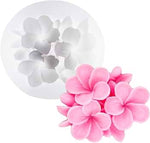 Flower-shaped silicone mold in pink and white on a white background